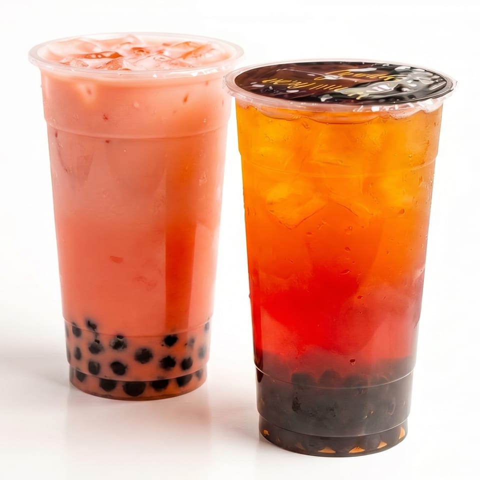 Two boba drinks, one pink and one orange and red, with tapioca pearls on a white background.